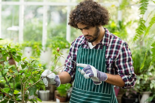 Worker using protective equipment during landscaping tasks